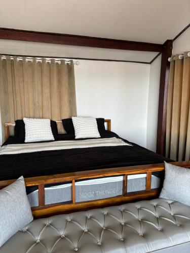a bedroom with a large bed and a couch at Star house old town lanta in Ko Lanta