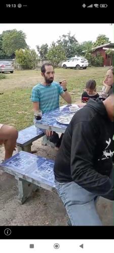 a group of people sitting at a picnic table at Sleep & fishing Pua in Nan
