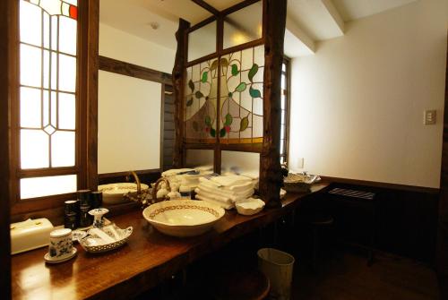 a bathroom with a counter with a sink and a mirror at Sasara in Gero