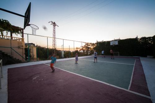 a group of people playingbasketball on a tennis court at Crystal Hotel Bodrum in Gumusluk