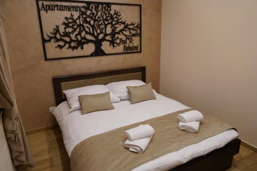 a bedroom with a large bed with towels on it at Apartamenty pod Dębami - noclegi Beskid Niski in Odrzechowa