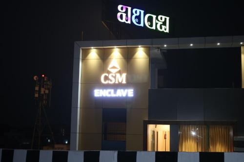 a sign on the side of a building at night at Hotal Virinchi Ultra Comforts - Good Rooms - Brand New Building in Tirupati