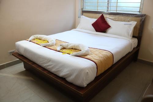 two beds in a room with towels on them at Hotal Virinchi Ultra Comforts - Good Rooms - Brand New Building in Tirupati