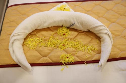 a pile of flowers on top of a bed at Hotal Virinchi Ultra Comforts - Good Rooms - Brand New Building in Tirupati