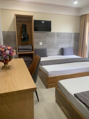 a hotel room with two beds and a table at Thiên Các Hotel in Quy Nhon
