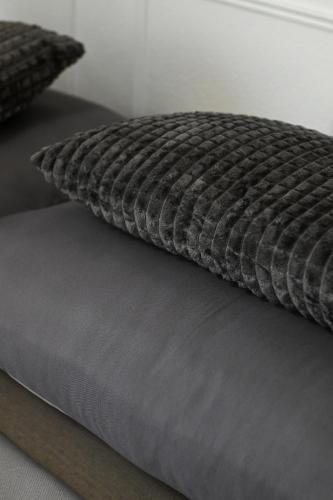 a bed with a pillow on top of it at Central appartment in Alexandroupoli