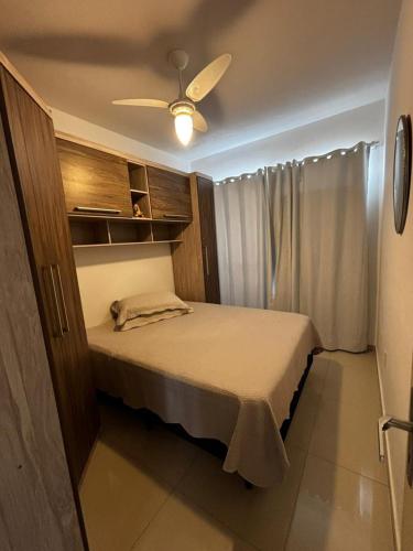 a bedroom with a bed with a ceiling fan at Apartamento 01 quarto 5min da Praia Baln Camboriu in Balneário Camboriú