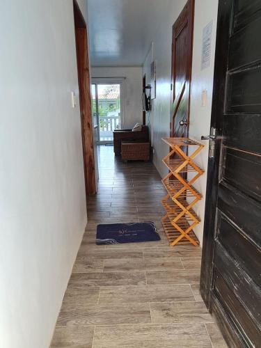 a hallway with a wooden door and a tiled floor at Tablas Seaview Homestay in Ferrol