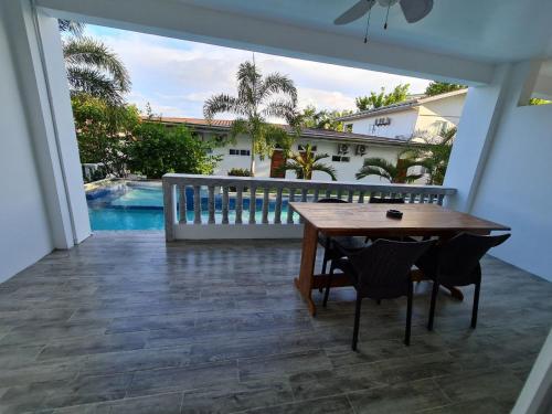 a patio with a table and chairs and a pool at Tablas Seaview Homestay in Ferrol