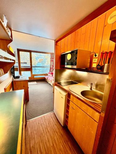une petite cuisine avec un évier et un micro-ondes dans l'établissement Studio ARCS 1800 - Belles Challes, 5 personnes, avec casier, à Bourg-Saint-Maurice