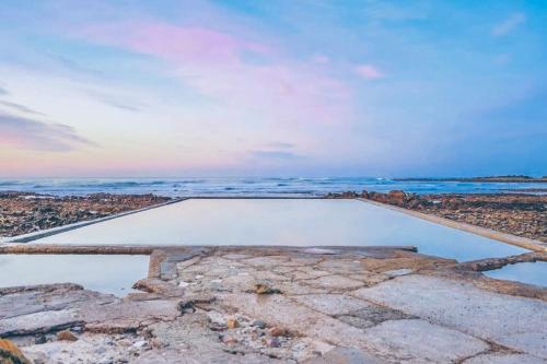 a pool of water sitting on top of a field at Sakkie se Dakkie in Agulhas