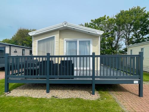 a large bench in front of a house at Luxury Coastal Bay Holiday Home in Hartley
