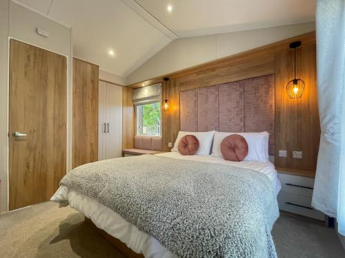 a bedroom with a large bed and a window at Luxury Coastal Bay Holiday Home in Hartley