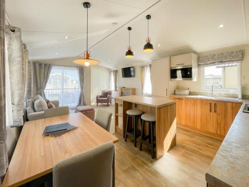 a kitchen and living room with a wooden table at Luxury Coastal Bay Holiday Home in Hartley