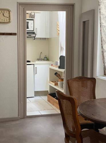 une cuisine avec une table et des chaises ainsi qu'une salle à manger dans l'établissement Logement Cosy à Périgueux avec 2 Chambres, Wifi fibre, à Périgueux