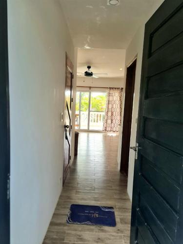 a hallway with a door and a blue rag on the floor at Tablas Seaview Homestay in Ferrol