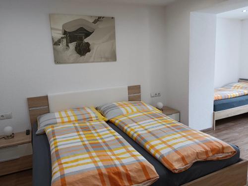 two beds sitting next to each other in a room at Apart Trisanna in Kappl