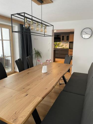a dining room with a wooden table and chairs at Buck Chalet in Steeg