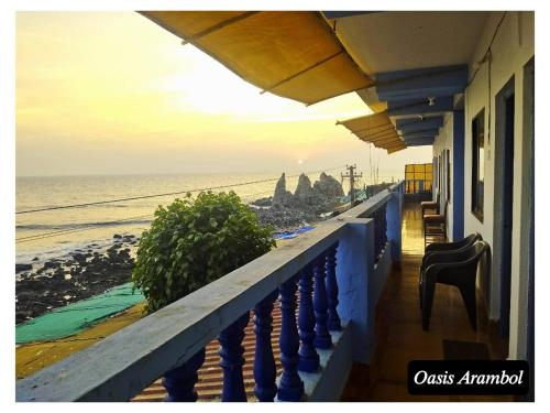 a balcony of a building with a view of the ocean at Oasis Arambol in Arambol