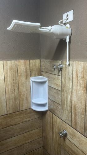 a bathroom with a white toilet in a room at Pousada Central in Bragança Paulista