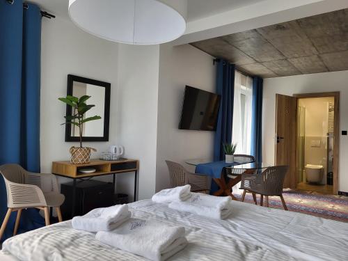 a bedroom with a bed and a table and chairs at USTROŃ RESIDENCE by VillaOlimpijska2 in Ustroń