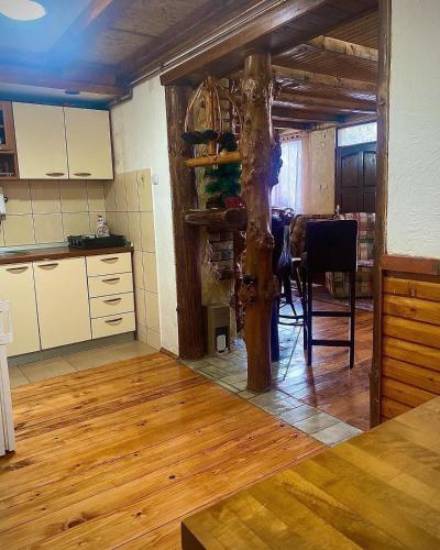 a kitchen with a tree in the middle of a room at Apartman Zlatarske Čari in Nova Varoš