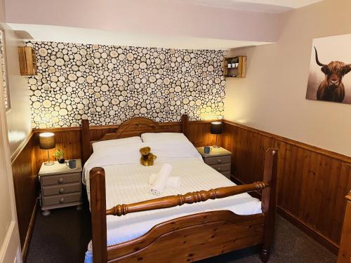 a bedroom with a bed and a cow on the wall at The Lake View Hotel in Llanberis