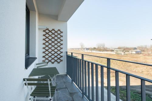 a balcony with chairs and a view of a field at AeroPrime - LOFT in Tunari