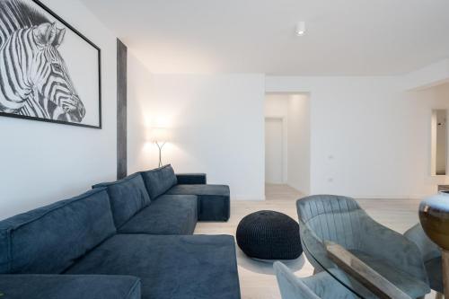 a living room with a couch and a zebra picture on the wall at AeroPrime - LOFT in Tunari