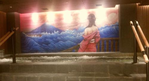 a large painting of a woman on a wall at Mercure Karawang in Karawang