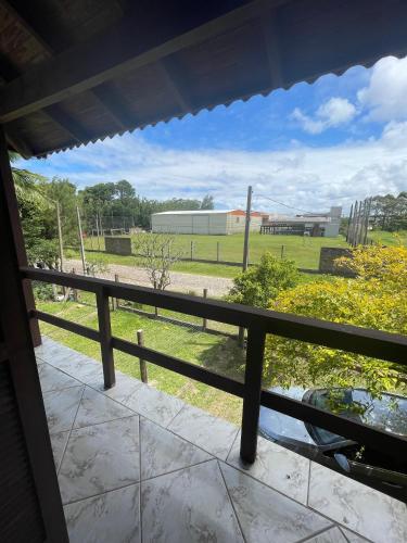 a view of a field from a balcony at Casa da Lagoa in Tramandaí