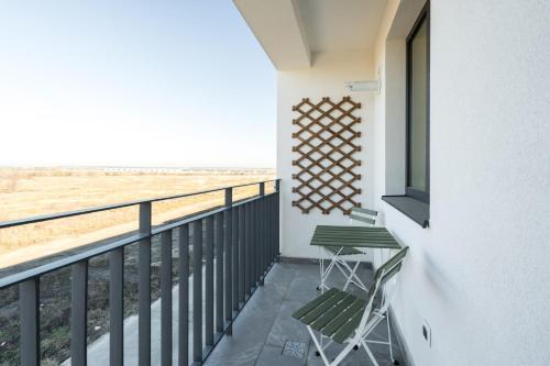 a balcony with two chairs and a view of the beach at AeroPrime - LOFT in Tunari