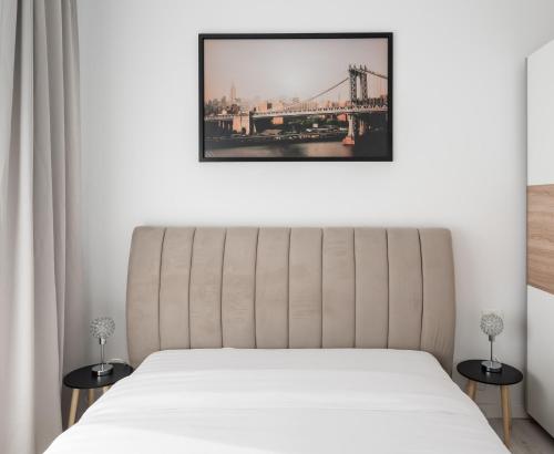 a bedroom with a bed and a bridge at AeroPrime - LOFT in Tunari