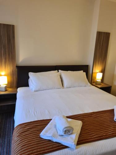 a hotel room with a bed with a towel on it at Jubilee Hotel Troodos in Troodos