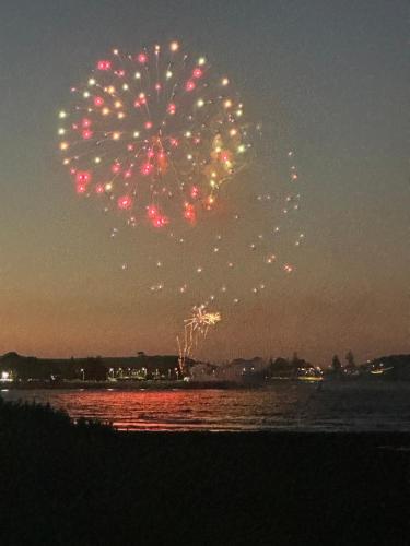 a firework display in the sky over the water at night at Devonport Breeze Escape in Devonport