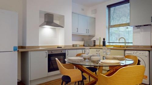 a kitchen with a table and chairs in a kitchen at Unique 3Bed Home Free Parking Near Meadowhall in Brightside
