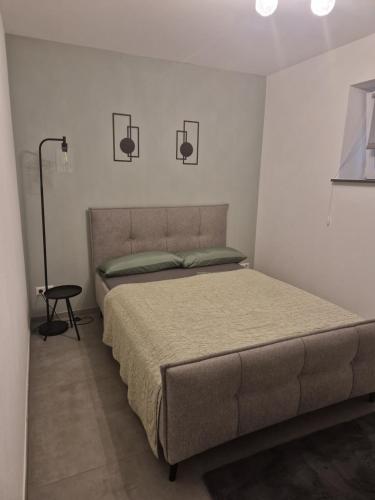 a bedroom with a bed and a lamp in it at FeWo Mösle in Lautrach