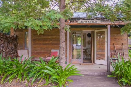 a wooden house with a porch with a sign on it at The Laurels of Chinchilla in Chinchilla