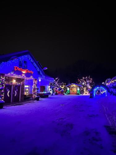 a house covered in christmas lights at night at Pietro Pokoje B&B Czarna in Czarna