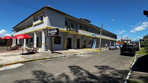 a building on the side of a street at Beira Mar Residencial in Capão da Canoa