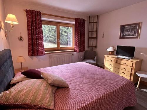 une chambre avec un lit, un bureau et une fenêtre dans l'établissement Appartement chaleureux avec terrasse, à 250m des pistes - Méribel, animaux acceptés - FR-1-180-344, à Méribel