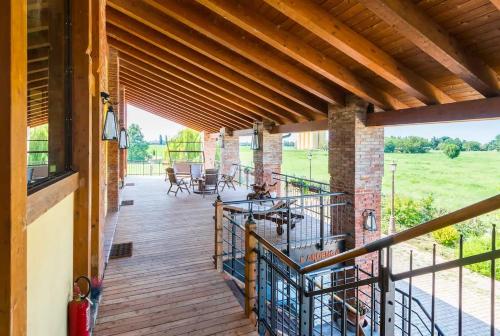 a porch of a house with a wooden deck at Parma Country Room in Montechiarugolo