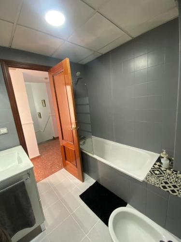 a bathroom with a sink and a tub and a toilet at LaCasa DeLola in Almodóvar del Río