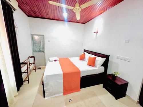 a bedroom with a bed and a ceiling fan at Angel Villa Unakuruwa Tangalle in Tangalle