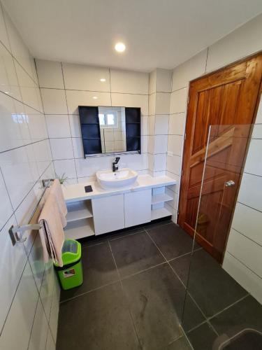 a bathroom with a sink and a mirror at Tablas Seaview Homestay in Ferrol