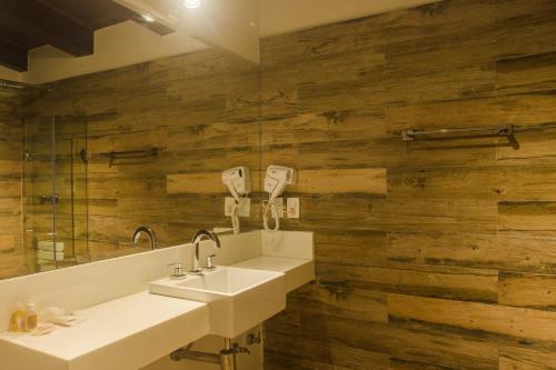 a bathroom with a sink and a mirror at La Pedrera Small Hotel & Spa in Búzios