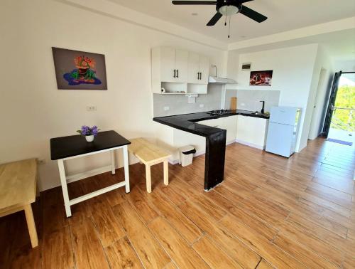 a living room with a kitchen and a dining room at Tablas Seaview Homestay in Ferrol
