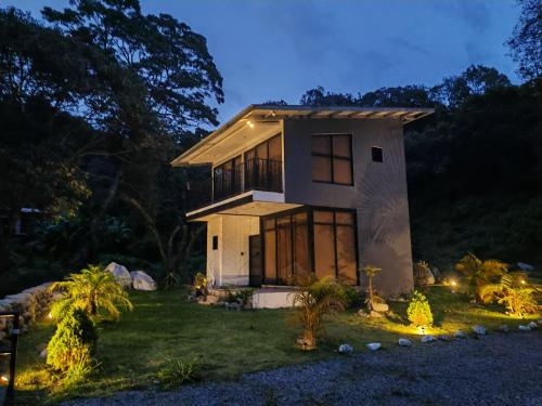a home lit up at night with lights at Cabaña Samu in Boquete