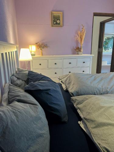 a bedroom with two pillows on the floor with a dresser at Chalet Mignon - your vacation oasis at Lake Brienz in Bönigen