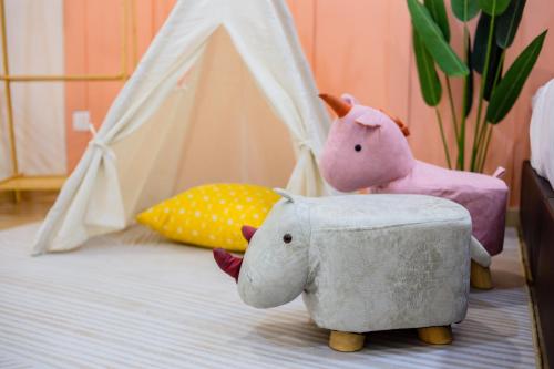 a bedroom with two stuffed elephants and a tent at Skudai Tun Aminah Cozy Home - Sutera Mall 6 mins in Skudai